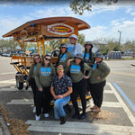 bachelorette group in front of pedal bike